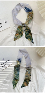 Detail of oil painting style narrow silk scarf on white shirt showing floral pattern