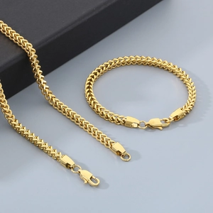 Detailed view of polished gold stainless steel dragon bone necklace and bracelet set