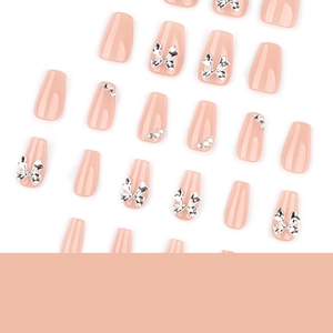 Pink press-on nails set with 3D silver bows and sparkling rhinestones in coffin shape