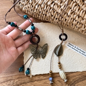 Vintage bohemian necklace with wood beads, butterfly charm and ceramic pendant detail