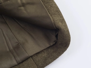 Detail of dark olive faux suede hat showing smooth satin lining and stitching