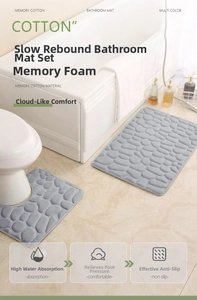 Close-up of grey embossed pebble texture on memory foam bathroom mat with anti-slip backing