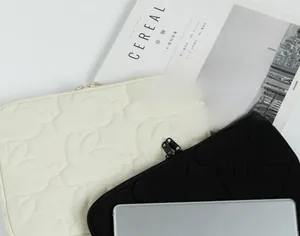 Quilted storage bag detail with embossed rabbit pattern and metal zipper closure
