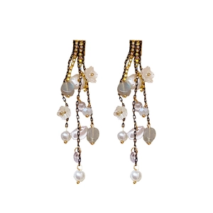 Elegant gold tassel earrings with pearls and floral charms in a vintage French style