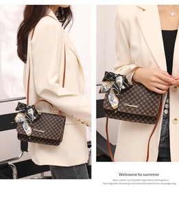 Close-up of brown monogram mini crossbody bag with elegant silk scarf and chain strap