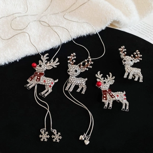 Close-up of reindeer necklaces and brooches with crystal rhinestones for Christmas