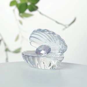 Detailed view of iridescent crystal shell ornament featuring a faceted pearl centerpiece