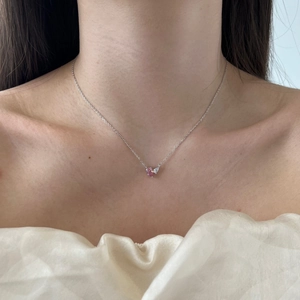 Detail of S925 sterling silver necklace with pink pear-shaped stone on a female model