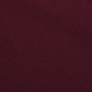 Détail macro du tissu tissé bordeaux haute densité avec une finition mate texturée