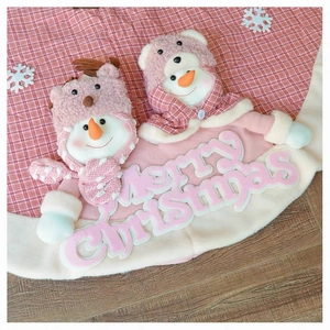 Detail of pink plush Christmas tree skirt with 3D snowman and Merry Christmas embroidery