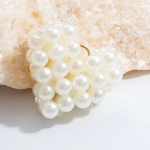 Close-up of handmade heart-shaped pearl pendant with elegant gold metal ring detail