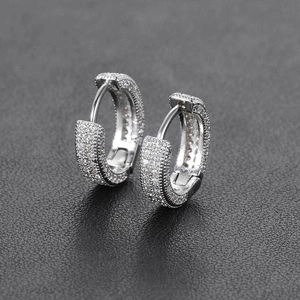 Macro shot of silver hip-hop hoop earrings with micro-pave cubic zirconia stones