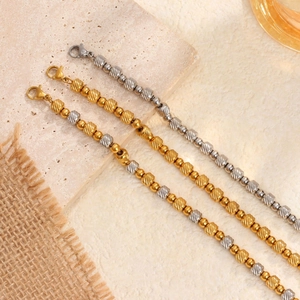 Three-piece textured gold and silver cylinder bead bracelet set with lobster clasp