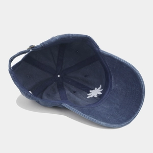 Navy blue washed cotton baseball cap with sun embroidery and adjustable metal buckle