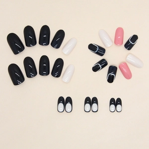 Modern minimalist black and pink press-on nails with white swirl designs in round shape