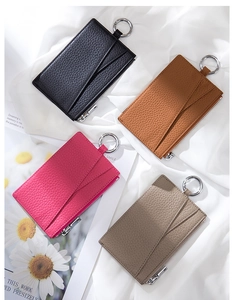 Detailed flat lay of litchi grain leather card holders in black, brown, rose, and taupe