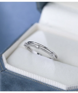 Macro shot of minimalist S925 sterling silver double-layer ring with sparkling zircons