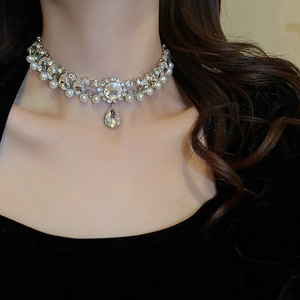 Close-up of a silver pearl choker with sparkling crystals and water drop pendant