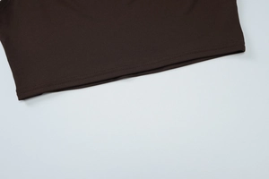 Detailed close-up of double-needle hem stitching and brown knitted fabric texture