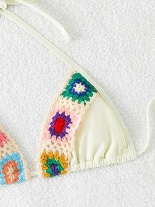 Detail of cream bikini top with colorful handmade crochet floral embroidery trim