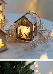 Close-up of wooden Christmas house pendant with warm LED light and laser-cut deer pattern