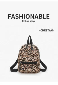Detail of trendy mini cheetah print canvas backpack featuring front zip pocket and straps