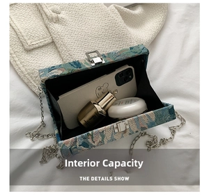 Internal view of floral chain bag showing capacity for phone and cosmetics
