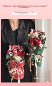Detailed view of Christmas bouquet with teddy bear, red roses and reindeer wrapping paper