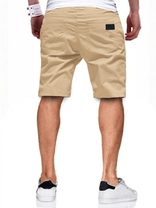 Rear view detail of khaki casual sports shorts with back pocket and DE label