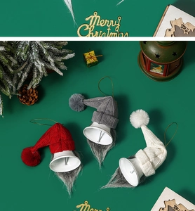 Three festive Christmas gnome bells in red, gray, and white on a green holiday backdrop