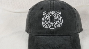 Close-up of vintage washed grey cotton baseball cap with white tiger head embroidery