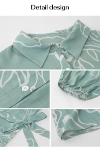 Detail view of the green geometric print dress featuring collar, buttons, and elastic cuffs