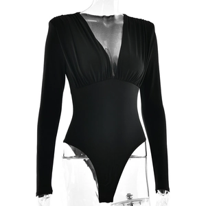 Close-up of black V-neck bodysuit featuring elegant pleated details and slimming long sleeves