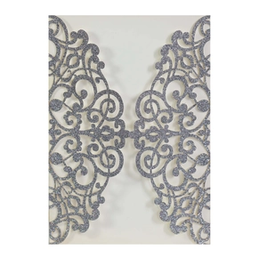 Detail of laser-cut glitter paper wedding invitation with ornate silver scrollwork