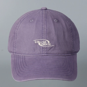 Detail of lavender cotton baseball cap featuring white Collaborate embroidery on front