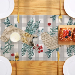 Christmas table runner with festive stocking and grey plaid pattern on wooden table