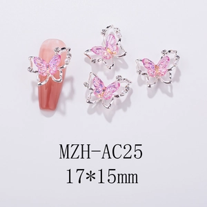 Macro shot of 3D butterfly nail charms with pink crystal and silver hollow metal