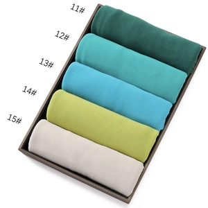 Close-up of five colorful jersey cotton scarves in numbered rolls from shades 11 to 15