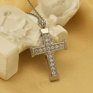 Silver stainless steel cross necklace with inlaid crystals on an elegant background