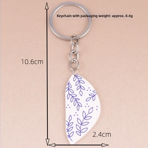 Detail view of bohemian floral acrylic keychain with 10.6cm length and blue leaf patterns