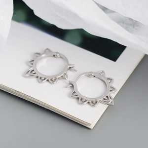 Detailed view of vintage silver S925 earrings with unique hollow patterns and serrated edges