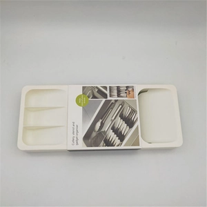 Detail view of expandable cutlery tray organizer with multiple storage compartments