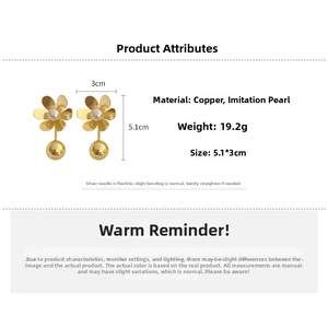 Detail view of gold flower petal earrings with pearl center and large metal ball drop