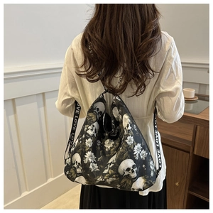 Detail of nylon drawstring tote with skull flower print and LOVE lettered straps