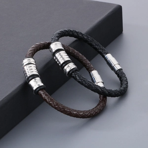 Close-up of black and brown braided leather bracelets with silver magnetic clasps