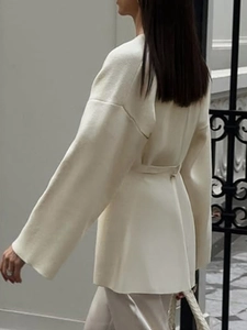Elegant white knit cardigan for women featuring a back tie-waist detail and soft long sleeves