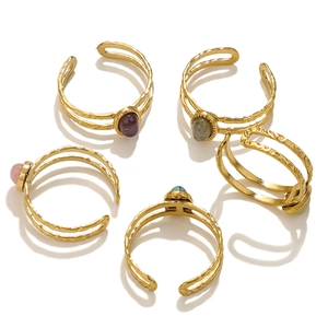 Set of five gold hammered stainless steel open rings with colorful semi-precious gemstones