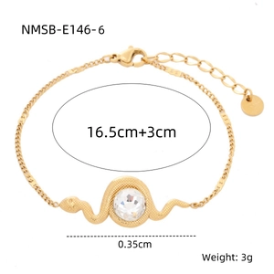 Detail of snake shaped gold bracelet with round gemstone and adjustable chain closure