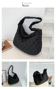 Detail view of large quilted black crossbody bag featuring classic rhombus patterns