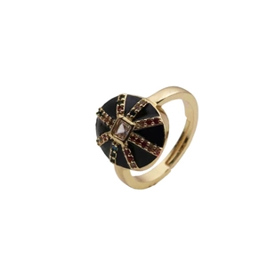 Vintage gold ring featuring a black disc set with colorful zircon stones on a white background